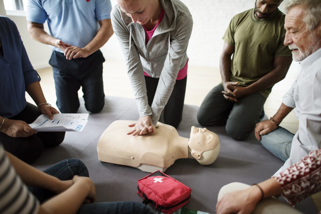 roup of diverse people in cpr training class