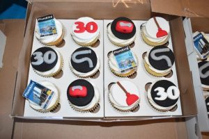 Plumbing Africa cupcakes and branded bottles.