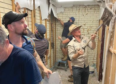 IWSH International Program director and long-time WorldSkills Australia ambassador Grant Stewart leadvolunteers in demolition works.